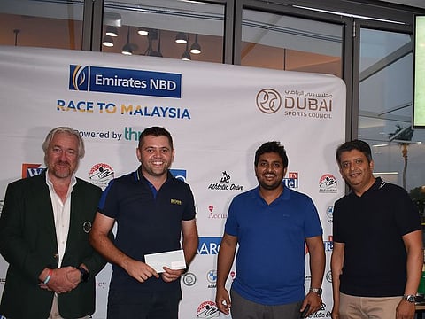 Wesley Burke wins Division 2 and receives his prize from EGC Captain Campbell Steadman, Thriwe's CEO Dhruv Verma and Emirates NBD Business Head Faisal Saeed.