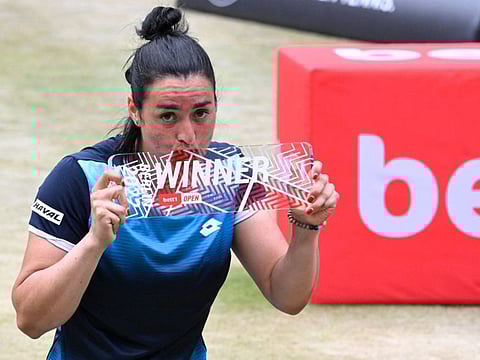 Ons Jabeur celebrates with the trophy after winning the final against Switzerland's Belinda Bencic at the Women's Bett1 Open in Berlin on Sunday. The Tunisian will be pairing with Serena Williams.