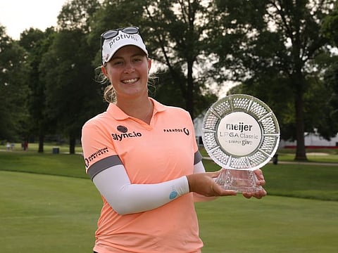 Jennifer Kupcho of the United States holds the trophy after winning the Meijer LPGA Classic at Blythefield Country Club on Sunday.