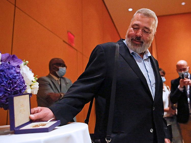 Russian journalist Dmitry Muratov poses to members of the media as he attends an event before the auctioning his Nobel Peace Prize medal to support children displaced by the war in Ukraine, in New York, on June 20, 2022.  