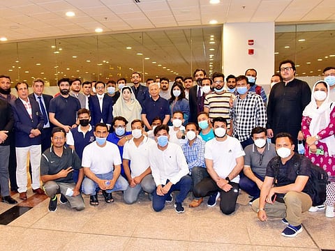 Federal Minister for Education Rana Tanveer Hussain with the Pakistani students at the Islamabad airport prior to their departure for China.