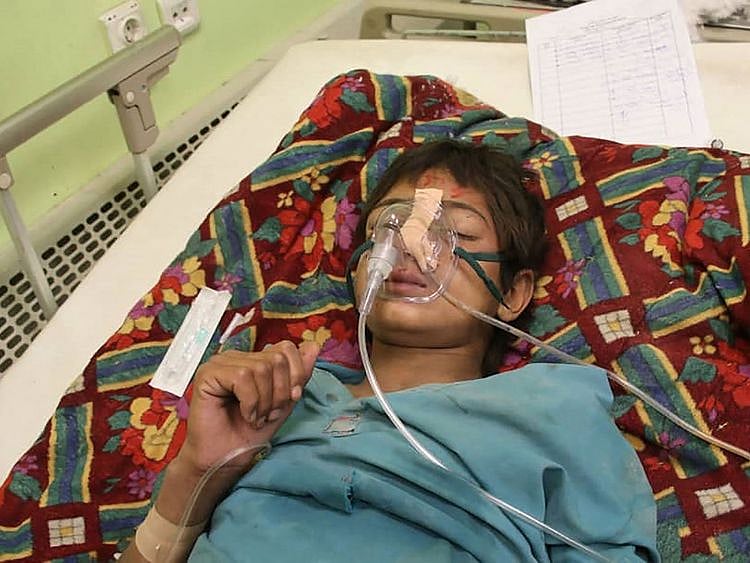  A young survivor of the quake receives basic medical treatment.