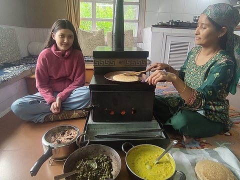 Reeta Thakur with daughter Adya (left) making a home cooked meal of morrells with red rice and fiddlehead ferns