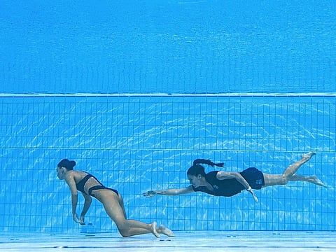 Team USA coach Andrea Fuentes (right) rescues unconscious artistic swimmer Anita Alvarez from the bottom of the pool 