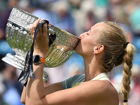 Czech Republic's Petra Kvitova celebrates and kisses the trophy after winning against Latvia's Jelena Ostapenko at the end of their women's singles final tennis match at the Eastbourne International tennis tournament in Eastbourne, southern England.