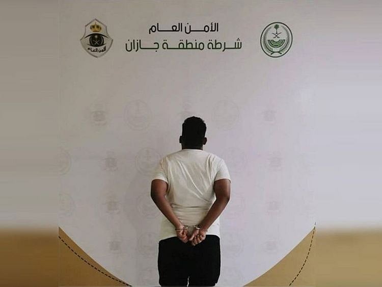 The suspect appears in a police picture.