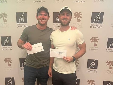 Winners of the Emirates US Open Championship run alongside the US Open, Lyndon Smith (left) and George Clarke at Emirates Golf Club.