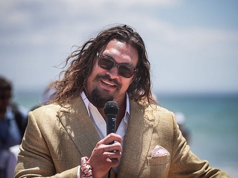 US actor Jason Momoa delivers a speech during the Youth and Innovation Forum at Carcavelos beach in Oeiras, outskirts of Lisbon on June 26, 2022.