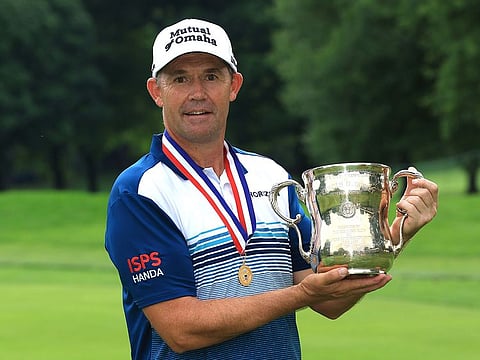 Padraig Harrington of Ireland poses with the trophy after winning the U.S. Senior Open Championship.