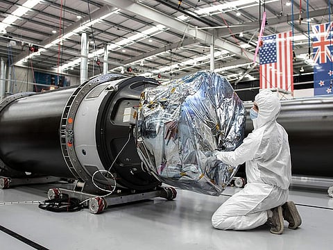 In this photo released by Rocket Lab, a technician works on a component of Rocket Lab's Electron rocket ahead of the launch on the Mahia peninsula in New Zealand on March 10, 2022. 