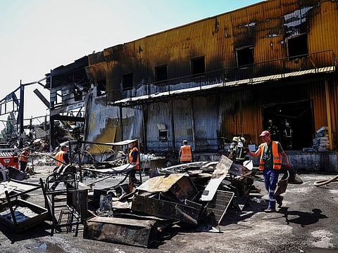 Rescuers work at a site of a shopping mall hit by a missile strike, as Russia's attack on Ukraine continues, in Kremenchuk, in Poltava region, Ukraine June 28, 2022.