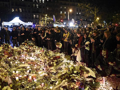 In this file photo taken on November 15, 2015 People gather at a makeshift memorial in front of the Bataclan theatre, one of the site of the attacks in Paris.