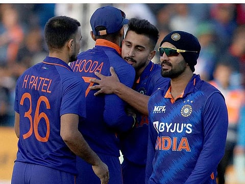Indian pacer Umran Malik celebrates with century-maker Deepak Hooda, Harshal Patel and Dinesh Karthik after guiding India to a four-run win in the second Twenty20 International on Tuesday.
