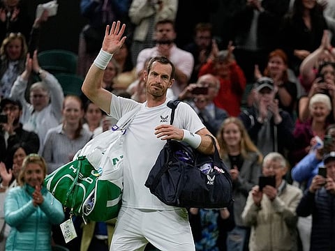 Britain's Andy Murray waves after losing the singles tennis match against John Isner of the US on day three of the Wimbledon tennis championships in London, Wednesday, June 29, 2022.