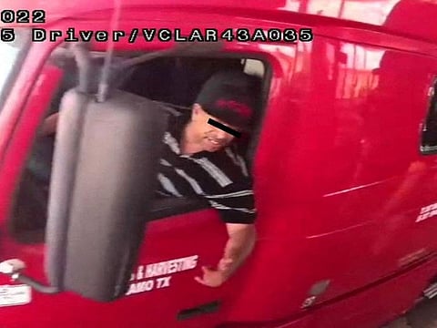 The alleged driver of a truck carrying dozens of migrants, Homero Zamorano Jr, drives through a security checkpoint in this surveillance photograph in Laredo, Texas, in this handout photo distributed to Reuters on June 29, 2022.