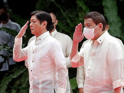 Incoming Philippine president Ferdinand Marcos Jr., left, and outgoing President Rodrigo Duterte, second left, salute during Marcos' inauguration ceremony at the Malacanang Presidential Palace grounds in Manila, Philippines, Thursday, June 30, 2022.
