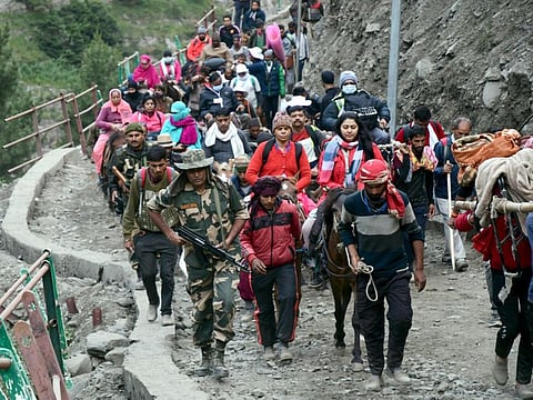 The first batch of pilgrims cross the mountain trails using palanquins and horses as they are on their way to the Amarnath cave through the Baltal route, on Thursday, June 30, 2022.