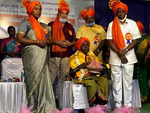 Shantaram Siddi (right) during the felicitation of a folk artist at the Siddi Folk Festival in Sambrani.