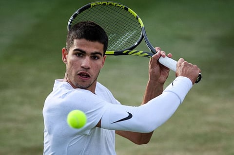 Spain's Carlos Alcaraz returns the ball to Netherlands' Tallon Griekspoor during their men's singles match on the third day of the Wimbledon Championships.