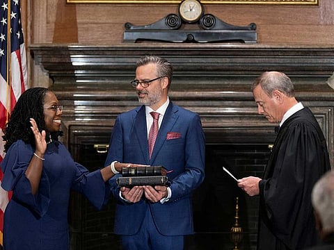 Judge Ketanji Brown Jackson takes her constitutional oath of office as an Associate Justice of the US Supreme Court administered by Chief Justice John Roberts as Jackson’s husband Patrick Jackson holds the Bible in a handout image provided by the U.S. Supreme Court from ceremonies held at the Supreme Court building in Washington, U.S., June 30, 2022. 