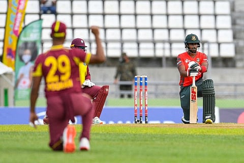 Munim Shahriar (right) of Bangladesh kneels for the Black Lives Matter movement during the first T20I between West Indies and Bangladesh at Windsor Park in Roseau, Dominica.