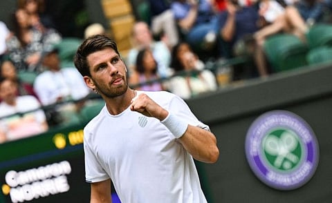 Britain's Cameron Norrie celebrates winning a point against US player Tommy Paul during their round of 16 men's singles tennis match on the seventh day of the 2022 Wimbledon Championships at The All England Tennis Club in Wimbledon, southwest London.