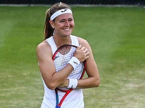 Marie Bouzkova of the Czech Republic celebrates defeating France's Caroline Garcia in a fourth round women's singles match on day seven of the Wimbledon tennis championships in London.