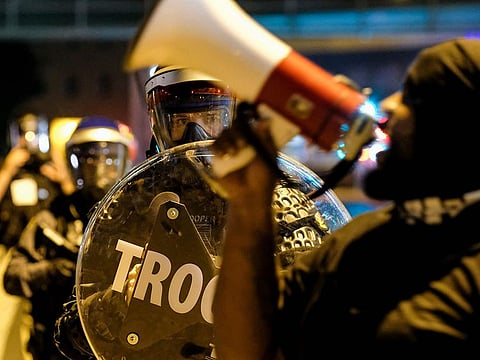 Troopers in riot gear watch as demonstrators gather outside Akron City Hall to protest the killing of Jayland Walker, shot by police, in Akron.