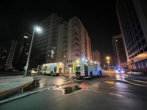 Abu Dhabi Police and Civil Defence personnel at work to bring the fire under control in the wee hours on Monday.   
