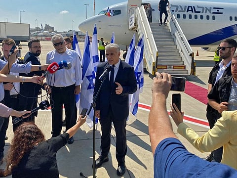 Israel's Prime Minister Yair Lapid speaks to the press ahead of boarding his flight to France, at Israel's Ben Gurion Airport in Lod on July 5, 2022.  