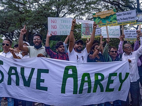People protest against the proposed felling of trees for a Metro car shed project at Aarey Colony in Mumbai, India, on July 3, 2022. The proposed location the car shed is a 1,800-hectare forest patch adjoining the Sanjay Gandhi National Park, considered Mumbai’s lungs. 