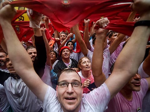 Participants wave their red scarves during the "Chupinazo" (start rocket) opening ceremony to mark the kick-off of the San Fermin Festival outside the Town Hall of Pamplona in northern Spain on July 6, 2022.