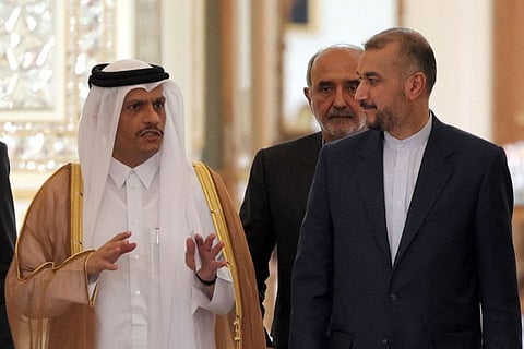 Iran's Foreign Minister Hossein Amir-Abdollahian and Qatar's Foreign Minister Sheikh Mohammad bin Abdul Rahman bin Jassim Al Thani arrive for a joint press conference at the foreign ministry headquarters in the capital Tehran on July 6, 2022. 