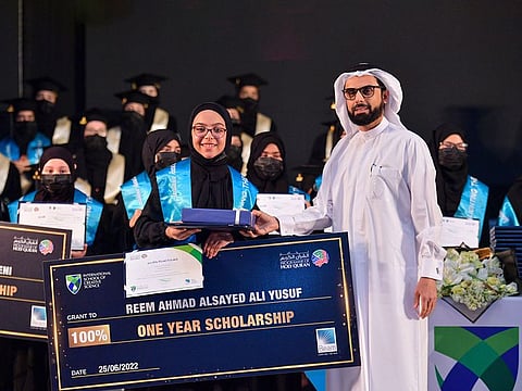 Salah Bukhatir, Chairman of BEAM, awards a student with a full scholarship for memorising the Holy Quran