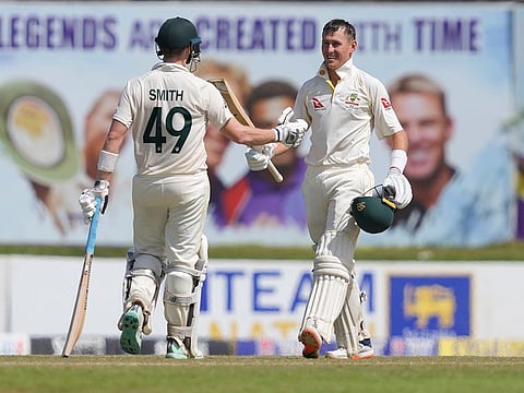 Australia's Marnus Labuschagne (right) celebrates scoring a century with partner Steven Smith during the first day of the second Test against Sri Lanka in Galle, Sri Lanka on Friday.