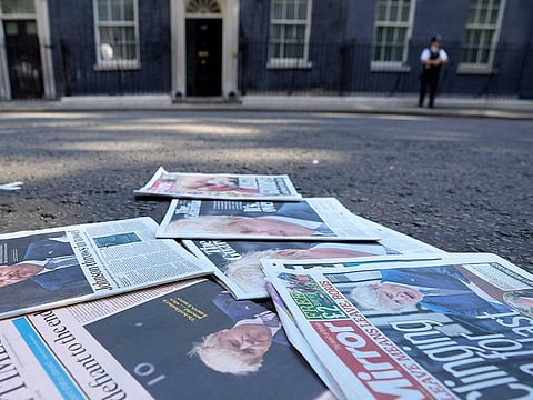 Newspapers lie on the street, opposite 10 Downing Street in London, Friday, July 8, 2022.  