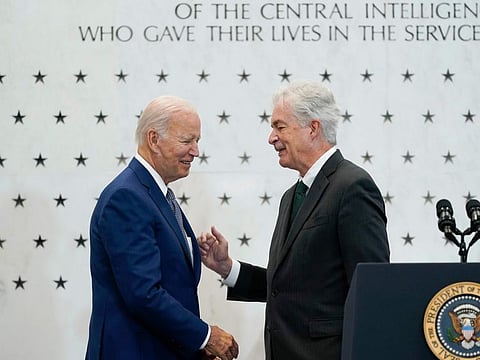 President Joe Biden, left, talks with Central Intelligence Agency Director William Burns, right, as he is introduced to speak at the CIA headquarters in Langley, Va., Friday, July 8, 2022.