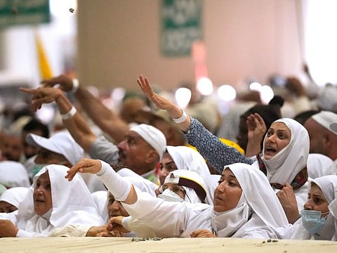 Pilgrims cast stones in the symbolic stoning of the devil ritual during the Hajj pilgrimage, in Mina, near the city of Mecca, on July 10, 2022. 