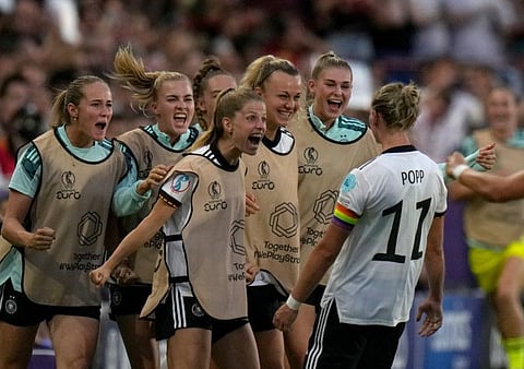 Germany's Alexandra Popp (right) celebrates after scoring her side's second goal during the Women Euro 2022 group B soccer match against Spain at Brentford Community Stadium in London, England.