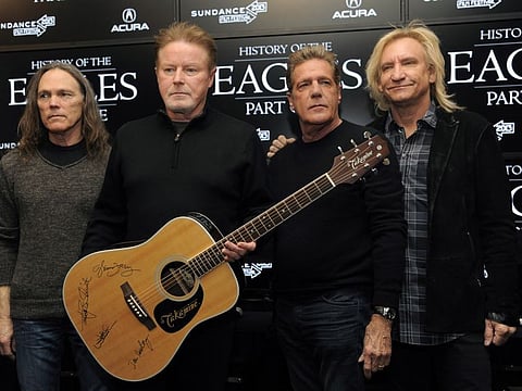 Members of The Eagles, from left, Timothy B. Schmit, Don Henley, Glenn Frey and Joe Walsh pose with an autographed guitar after a news conference at the Sundance Film Festival, in Park City, Utah, Jan. 19, 2013.