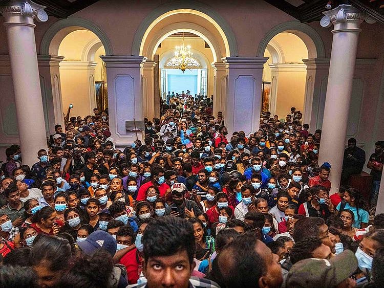 People throng President Gotabaya Rajapaksa’s official residence for the second day after it was stormed in Colombo, Sri Lanka, Monday, July 11, 2022.