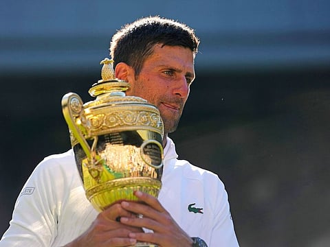 Serbia’s Novak Djokovic holds the winners trophy after beating Australia’s Nick Kyrgios in the men’s singles final of the Wimbledon tennis championships in London on July 10, 2022. Djokovic’s biggest fight is to crossover into the oft used phrase ‘people’s champion’. 