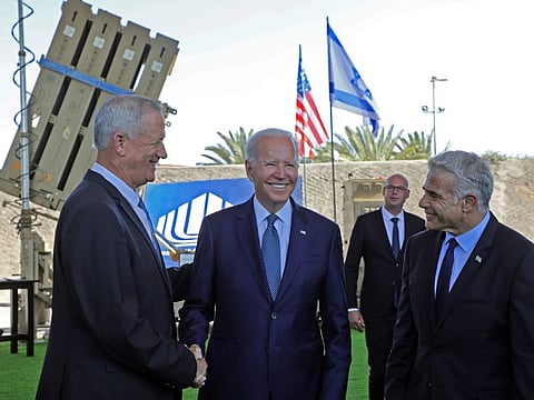 US President Joe Biden, Israeli caretaker Prime Minister Yair Lapid, right, and Defence Minister Benny Gantz, stand in front of Israel's Iron Dome defence system during a tour at Ben Gurion Airport near Tel Aviv, Wednesday, July 13, 2022.  