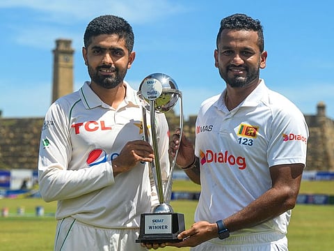 Pakistan captain Babar Azam (left) and his Sri Lankan counterpart Dimuth Karunaratne pose with the winners' trophy for the two-Test series which gets under way on Saturday.