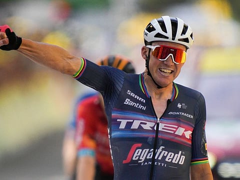 Denmark's Mads Pedersen celebrates as he crosses the finish line to win the 193-km 13th stage of the Tour de France  between Le Bourg d'Oisans and Saint-Etienne on Friday.
