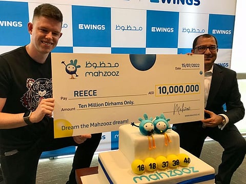 British expatriate Reece receives the winner's cheque from Farid Samji.  