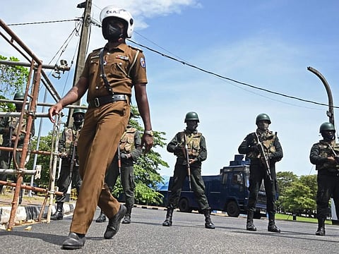 Members of security personnel stand guard in front of Sri Lankan parliament building in Colombo on July 16, 2022.  