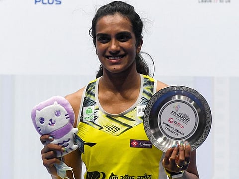 Indias PV Sindhu poses on the podium following her victory against Chinas Wang Zhiyi in their womens final match at the Singapore Badminton Open in Singapore.