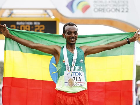 Tamirat Tola of Team Ethiopia celebrates winning gold in the Men's Marathon on day three of the World Athletics Championships Oregon22 at Hayward Field in Eugene, Oregon. 