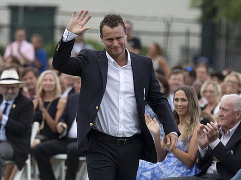 Lleyton Hewitt, of Australia, acknowledges applause as he walks to the podium during induction ceremonies at the International Tennis Hall of Fame in Newport.